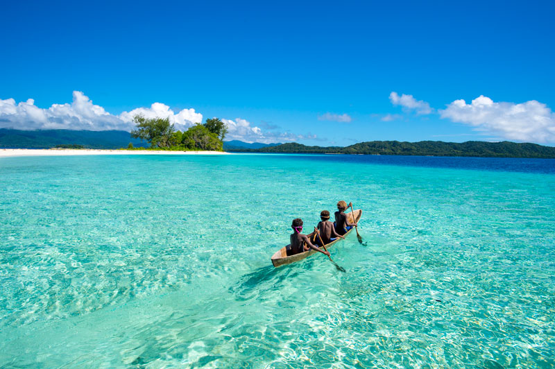 Dive beneath the surface in Solomon Islands Kids paddling along the beautiful islands of Marau Sound