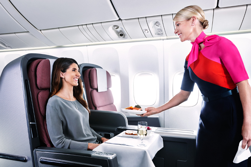 Air hostess hands guest a drink