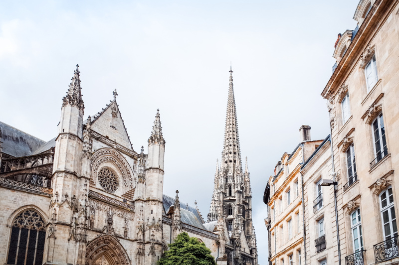 Ornate cathedral spire against blue sky, Bordeaux