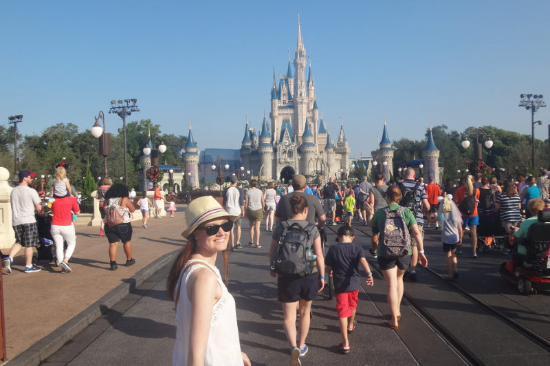 Travel Associate walks toward Disney World's Magic Kingdom