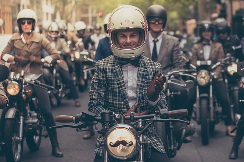 Men in old fashioned dress on motorbikes