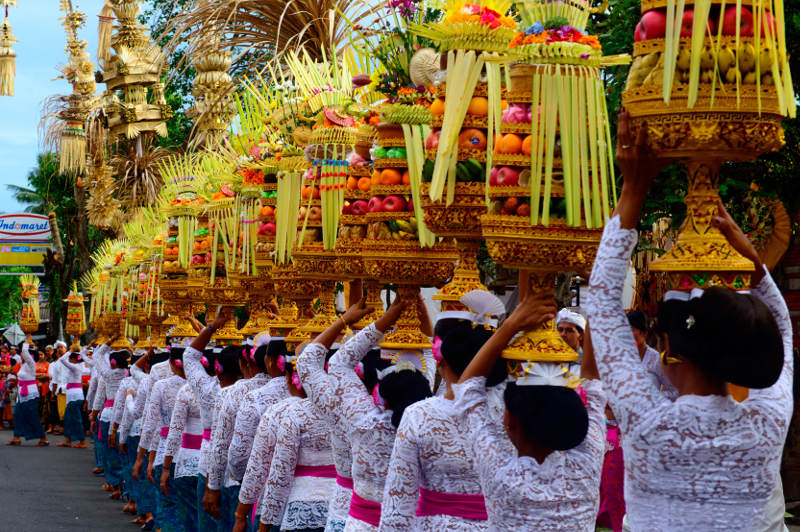 Traditional Balinese procession with fruit baskets carried on heads