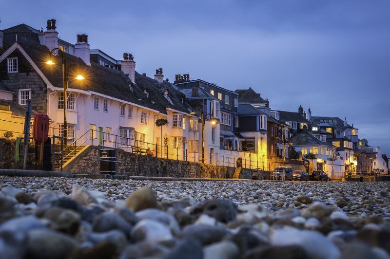 Seaside houses illuminated at night at Lyme Regis