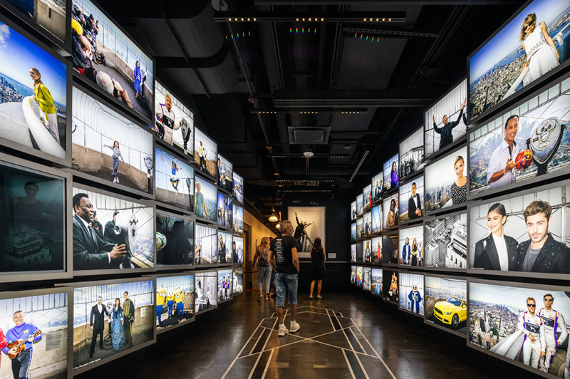 The experience on the second floor includes a gallery of celebrity visitors to the Empire State Building, leading to the elevator to the observation deck. Credit - Mark Wickens for The New York Times