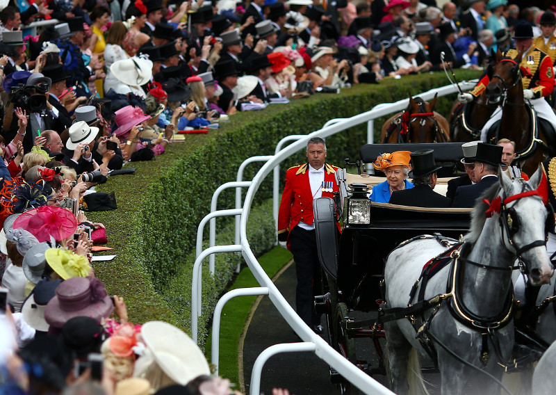 Queen Elizabeth II greets the crowd at races