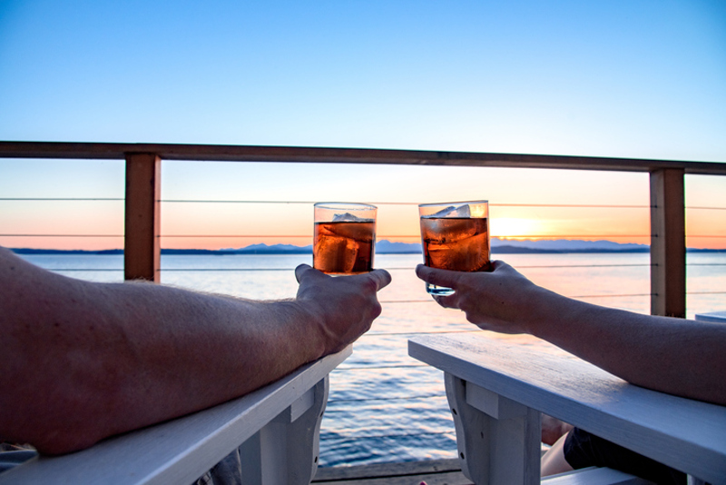 Couple drinking rum in sunset