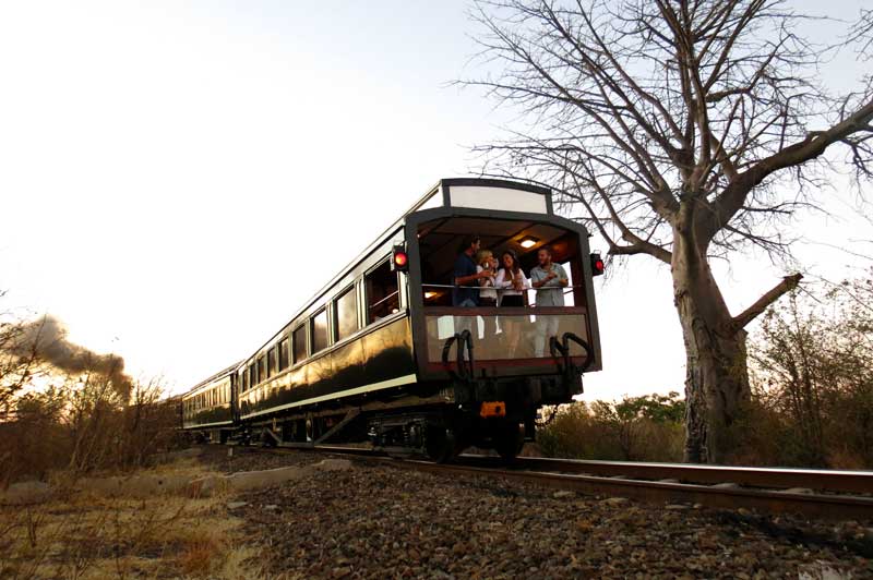 Zimbabwe. Victoria Falls. Steam train. Man looking out of window