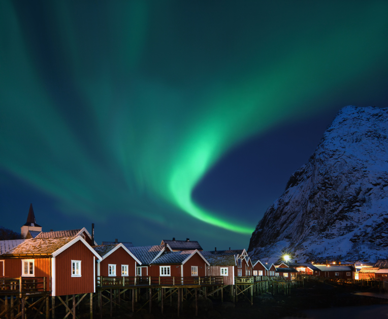 This image: The Aurora Borealis over the fishing village of Reine, Norway.
