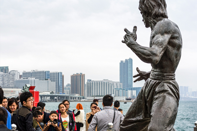 Statue of Bruce Lee on the Avenue of Stars, along the Tsim Sha Tsui waterfront. Image: Getty images.