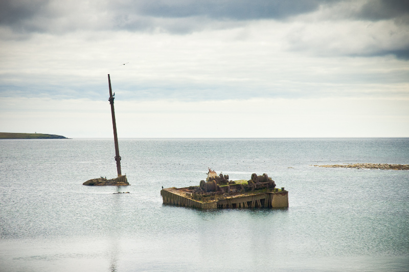 A wreck protrudes from the waters of Scapa Flow in Orkney, Scotland