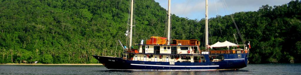 The Tui Tai ship is docked in a scenic, secluded bay